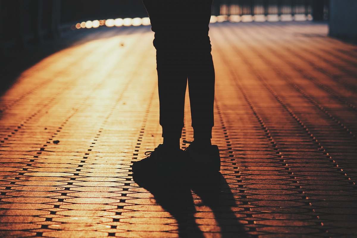 qasba canal silhouette of man standing on concrete pavement sharjah